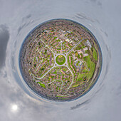 Aerial view of a tiny planet perspective of residential houses and roads in a circular layout with green spaces under a cloudy sky, Bilton Grange, Hull, England, United Kingdom.