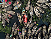 Aerial view of boats on the polluted Buriganga river with a clear perspective, Keraniganj, Bangladesh.