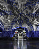 View of the Solna Centrum metro station, a cavernous space where raw rock meets artistic expression in a symphony of blue and white, Stockholm, Stockholm County, Sweden.