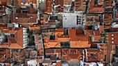 Aerial view of terracotta rooftops blanketing ancient streets, contrasting with the pale stone of open squares, Split, Split-Dalmatia County, Croatia.