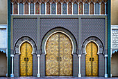 View of golden doors gleaming beneath intricate geometric patterns, a symphony of Moroccan artistry and architectural grandeur, Fes, Fez-Meknès, Morocco.