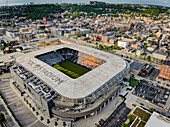 Cincinnati, United States - 18 July 2025: Aerial view of TQL Stadium, a modern concrete structure gleaming under the sun, contrasting with the surrounding urban sprawl.