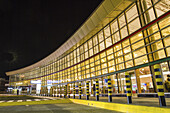 Nairobi, Kenya - 26 August 2014: View of the Jomo Kenyatta International Airport's terminal building, illuminated by vibrant lights against the dark sky.
