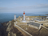 Aerial view of Pointe Saint-Mathieu's ancient abbey ruins and iconic lighthouse standing proud against the azure sea, Plougonvelin, Bretagne, France.