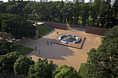 Aerial view of the Independence Monument with its circular design and Bangladeshi flag waving high amidst the lush greenery, Hazarali, Khulna Division, Bangladesh.
