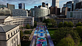 Aerial view of a symphony of structures and colors unfolds over the city, where the artful pavement meets the grandeur of civic buildings and modern skyscrapers, Denver, Colorado, United States.