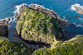 Aerial view of the rugged coastline where the turquoise sea meets the rocky shores, creating a stunning contrast of nature's beauty, Matapouri, Te Tai-tokerau, New Zealand.
