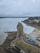 Aerial view of the imposing Tour Solidor standing defiant against the tide, its stone walls a stark contrast to the soft greys of the sky, Saint-Malo, Bretagne, France.