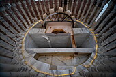 View of a marble structure with geometric patterns and golden accents, offering a unique perspective from below, emphasizing the craftsmanship, Kartarpur, Punjab, Pakistan.