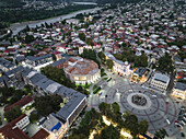 Aerial view of the vibrant central square and the distinctive Meskhishvili Theatre, surrounded by residential buildings, capturing the heart of the city, Kutaisi, Imereti, Georgia.