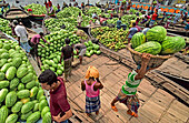 Dhaka, Bangladesh - 08 April 2018: View of a bustling river market, a vibrant scene of men and boats laden with piles of green watermelons under the open sky.