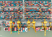 Chittagong, Bangladesh - 09 June 2022: Aerial view of stacked, multicolored shipping containers creating a vibrant tapestry of global trade at the bustling port terminal.