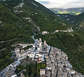 Aerial view of ancient towers rise above the clustered rooftops of Pacentro, nestled amidst the verdant embrace of Majella National Park, Pacentro, Province of L'Aquila, Italy.