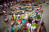 Pirojpur, Bangladesh - 03 August 2018: View of bustling boats laden with produce create a vibrant tapestry of colors and textures on the river, a lively hub of commerce and human activity.