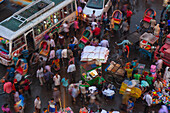 Dhaka, Bangladesh - 13 September 2015: Aerial view of vibrant chaos where buses, rickshaws, and bustling crowds converge, creating a mesmerizing dance of motion and color.