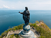 Aerial view of Cristo Rei statue standing tall against the azure sea, a beacon of faith overlooking the coastline, Dili, Díli, Timor-Leste.