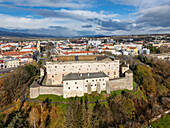 Aerial view of a medieval castle standing majestically atop a hill, overlooking the town square and distant mountains, Zvolen, Banskobystrický kraj, Slovakia.