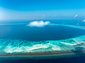 Luftaufnahme des türkisfarbenen Wassers und der Sandstrände, die einen faszinierenden Kontrast unter dem weiten blauen Himmel mit einer einzigen Wolke bilden, Fulhadhoo, Baa Atoll, Malediven.