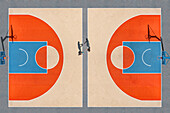 Luftaufnahme eines Basketballplatzes in kräftigen Orange- und Blautönen mit zwei Figuren, die in der Mitte des Platzes stehen, Charkiw, Oblast Charkiw, Ukraine.