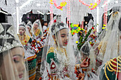 Sylhet, Bangladesh - 08 November 2022: View of young girls adorned in traditional attire, their faces painted white, amidst the vibrant colors and intricate decorations of a cultural celebration.