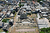Aerial view of the ancient Roman Theatre ruins juxtaposed against the modern urban landscape, a blend of history and contemporary life, Aosta, Valle d'Aosta, Italy.