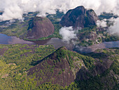 Aerial view of the majestic Cerros de Mavicure rises dramatically from the Amazonian rainforest, their dark rock contrasting with the verdant jungle, Puerto Inírida, Cerros Mavicure, Colombia.