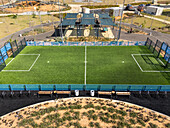 Aerial view of a vibrant green soccer field nestled amidst the serene landscape of a park, a haven for sports and recreation, Nahariyya, North District, Israel.
