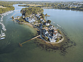 Aerial view of the picturesque Conleau peninsula, with its charming white-roofed houses nestled amid lush greenery, edged by the tranquil, shimmering waters, Presqu'île de Conleau, Bretagne, France.