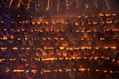 Narayanganj, Bangladesh - 09 November 2024: Aerial view of a sea of devotees gathered, their faces illuminated by countless flickering candles in a mesmerizing display of faith.