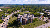 Aerial view of a cluster of castle-like structures stands proudly amidst a sea of green, a stark contrast to the flowing traffic, Cincinnati, Ohio, United States.