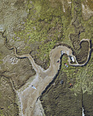 Aerial view of boats resting on the sandy banks of a winding river amidst a lush green landscape, Valdoviño, A Coruña, Spain.