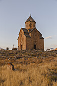 View of the ancient Noravank monastery standing proudly on the rocky outcrop, bathed in the warm glow of the setting sun, Areni, Vayots Dzor Province, Armenia.