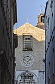 View of the Chiesa di San Francesco al Corso stands majestically, its stone facade bathed in warm sunlight, framed by the narrow street, Chieti, Abruzzo, Italy.