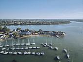 Aerial view of sailboats resting in the harbor, contrasting with the blue waters and the quaint buildings of the Presqu'île de Conleau, Presqu'île de Conleau, Bretagne, France.