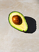 Halved avocado with stone