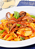 Pasta with baby octopus in tomato sauce
