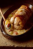 Roast veal roulade wrapped in bacon with a creamy sauce