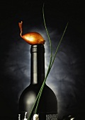 Bottle of wine, clove of garlic and stems of chives