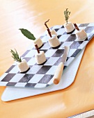 mini goat's cheeses on chessboard cheese platter