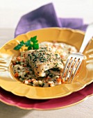 Steam-cooked halibut with diced vegetables and creamy sauce