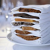 selection of sliced bread in napkins