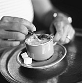 person stirring cappuccino