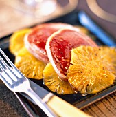 Slices of roast ostrich with pineapple