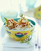 Bowl of rice noodles and prawn rolls