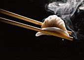 Chinese hakao ravioli on chopsticks