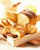 Croissants und Brioche auf Holztablett