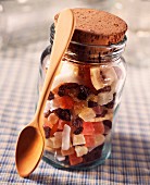 Jar of dried fruit with wooden spoon