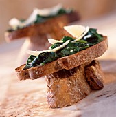 Spinach sprouts and parmesan on toast
