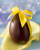 Chocolate Easter egg with yellow ribbon