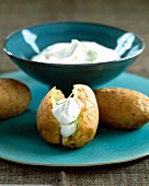 Baked potatoes with whipped cream and lime zests